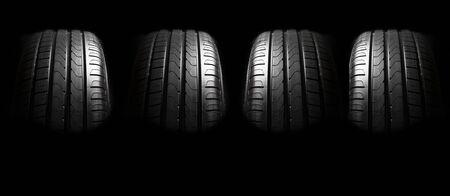 Car tires close-up wheel profile structure on black backgroundの写真素材