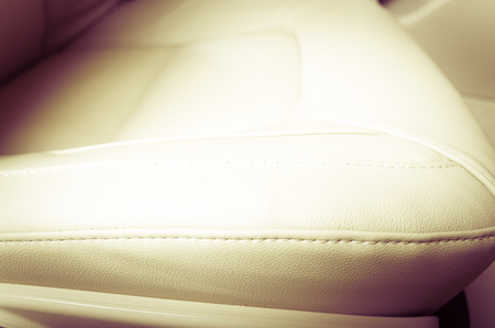 Part of  leather car seat with the unfocused car interior on the background, vintage filterの写真素材