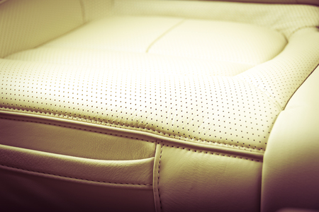 Part of  leather car seat with the unfocused car interior on the background, vintage filterの写真素材