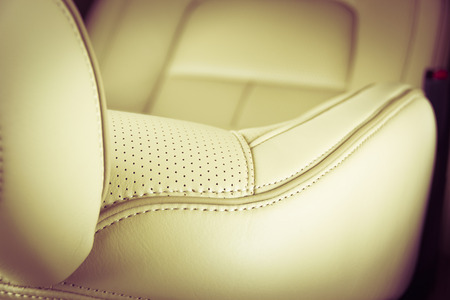 Part of  leather car seat with the unfocused car interior on the background, vintage filterの写真素材