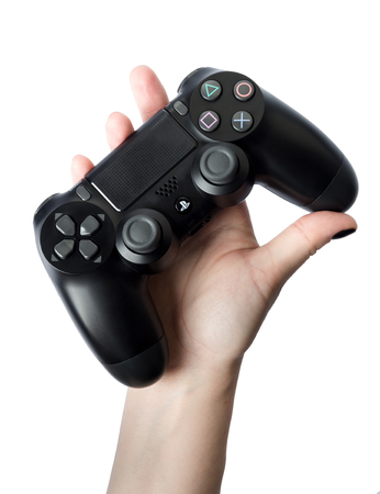 Sankt-Petersburg, Russia - 26 August, 2017: Sony PlayStation 4 game controller in gamers hand on...