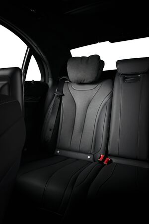 Back passenger seats in modern luxury car, frontal view, black leather