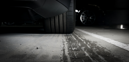 Sports car leaving wet tire prints on the asphaltの写真素材