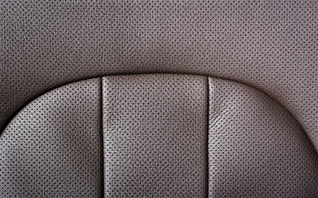 Modern sport car  red sand perforated leather interior. Part of  leather car headrest seat details.