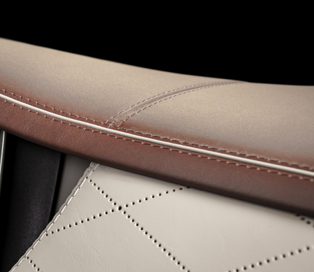 Part ofred andwhite perforated leather car seat detail with focus on the stitchの写真素材