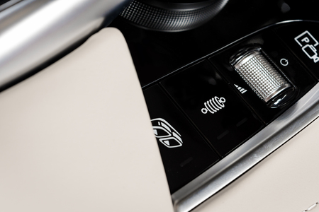 suspencion and media control buttons of a Modern car. Car interior details. White leather interior...