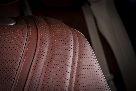 Modern sport car  red sand perforated leather interior. Part of  leather car headrest seat details.の写真素材