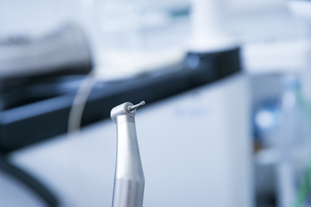 Dental instruments. Denta high speedl turbine. Dental diamond cylinder bur with hand-piece. Blurred dental offive background.の写真素材
