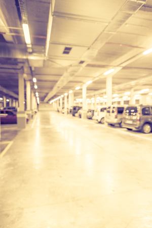 Blurred image/ Parking garage - interior shot of multi-story car park, underground parking with cars.の写真素材