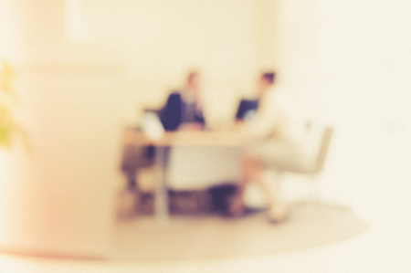 Businessmen blur in the workplace or work space of table work in office with computer or shallow depth of focus of abstract background.の写真素材