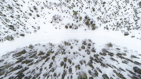 Aerial drone view of road in idyllic winter landscape. Street running through the nature from a birds eye view.の写真素材