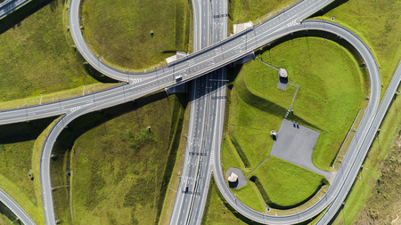 Aerial view of highway interchange  Road junction Aerial photo of a highway going through the forest