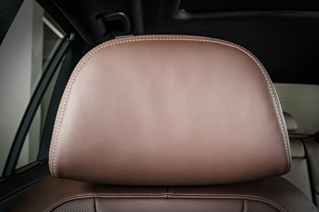 Modern luxury car  red perforated leather interior. Auto inside part of  leather car headrestの写真素材