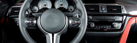 Modern luxury car Interior - steering wheel, shift lever and dashboard. Car interior luxury.Steering...