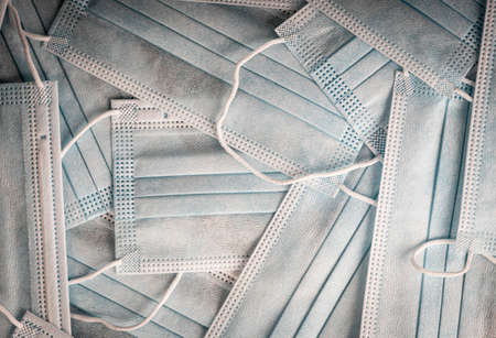 Close-up disposable medical masks in the stack detailed macro photo. Medical mask texture background