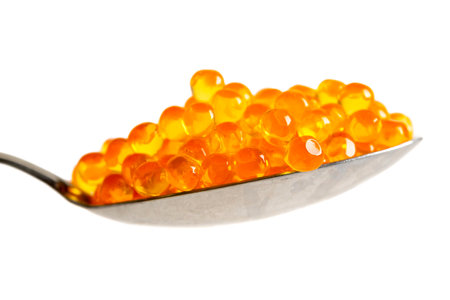 Red caviar in the silver spoon isolated on a white background with clipping path. Close up. Macro.の写真素材