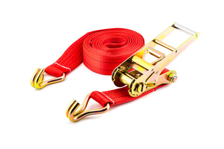 Trailer strop or strap in orange nylon and metal tie isolated over white background. Ratchet straps for cargo load control. Cargo restraint strapの写真素材