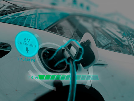 Power cable pump plug in charging power to electric vehicle EV car with modern technology UI control information display, car fueling station connected power cable alternative sustainable eco energyの写真素材