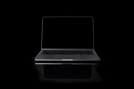 Photo of realistic modern laptop with blank screen in front of a dark black backgroundの写真素材