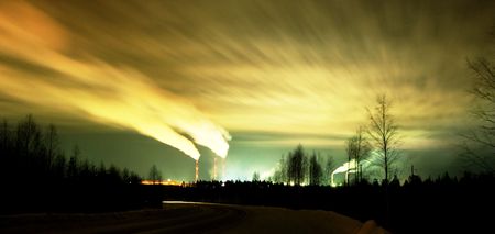 The smoke from the chimneys of mining plant. Dusk.の写真素材