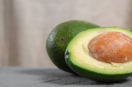 Avocado fruit and slice on concreteの写真素材