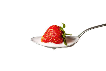 strawberry in the spoon full of yoghurtの写真素材