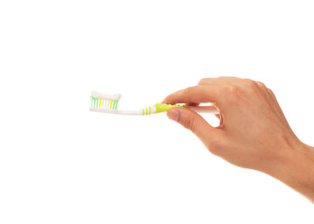 hand with toothbrush isolated over white backgroundの写真素材