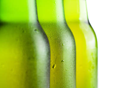 three green beer bottles over white backgroundの写真素材