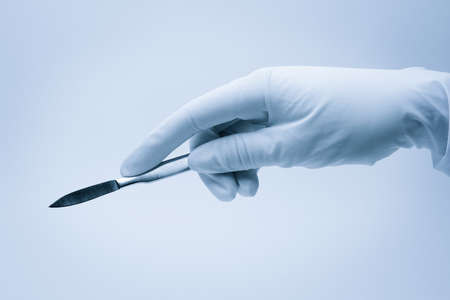 hand of surgeon with scalpel during surgeryの写真素材