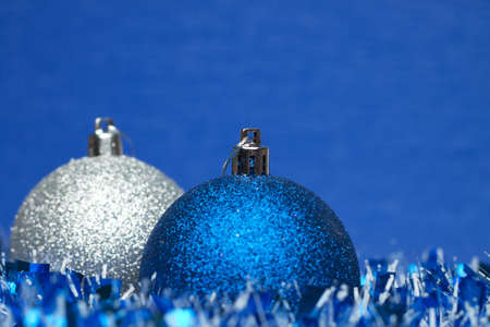 white and blue shiny christmas balls with tinselの写真素材