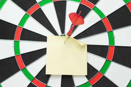 dart hit the centre of target and attaches stickerの写真素材