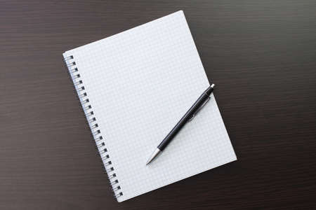 blank notebook and pen on the table