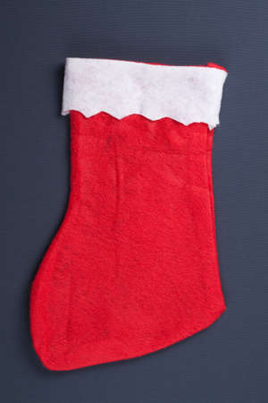 santas red stocking over grey background christmas concept