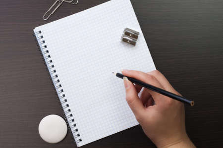 woman writing with pencil in the office