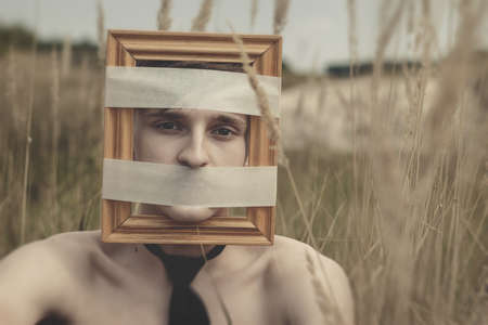 young modern man voiceless and boxed conceptの写真素材