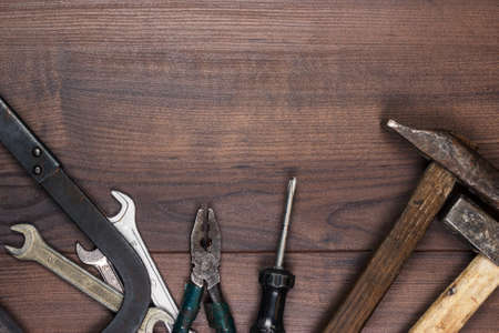 rusty construction tools on the wooden backgroundの写真素材