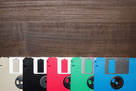 retro technology concept diskette on wooden backgroundの写真素材