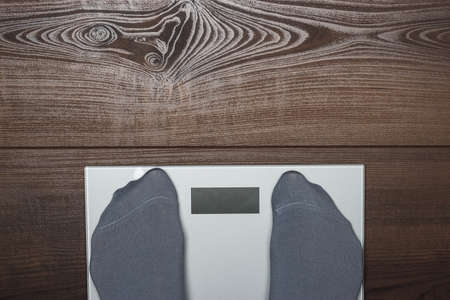 electronic scales on the wooden floorの写真素材