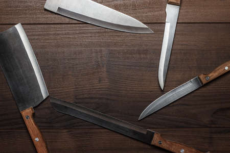 kitchen knifes on brown wooden table backgroundの写真素材