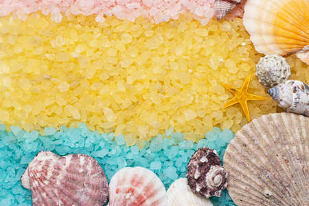 blue yellow pink bath salt and seashells backgroundの写真素材