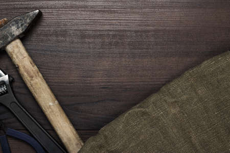 different rusty construction instruments on the wooden backgroundの写真素材