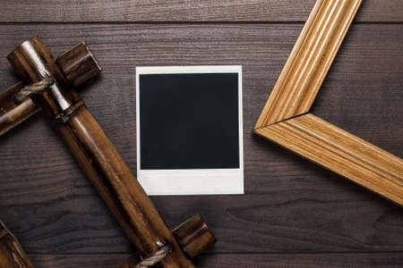 empty frames and old photo on the wooden tableの写真素材