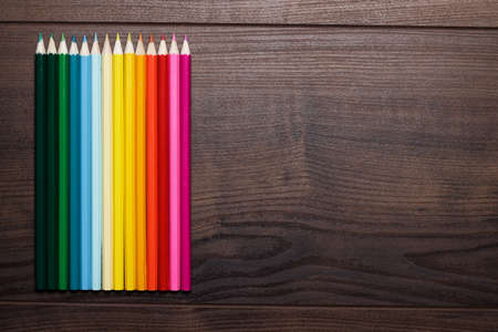 colorful pencils on the brown wooden tableの写真素材