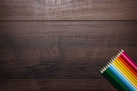colorful pencils on the brown wooden tableの写真素材