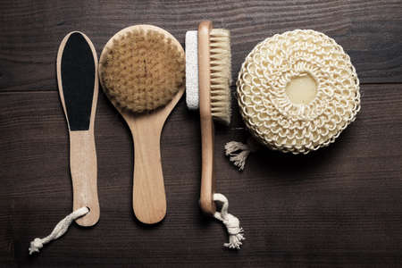 some bath accessories on the brown wooden background