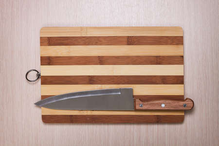 big knife and breadboard on tableの写真素材