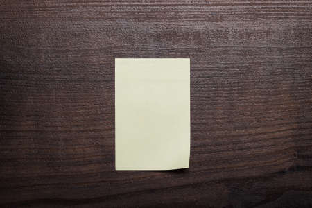 blank sticker on brown wooden table