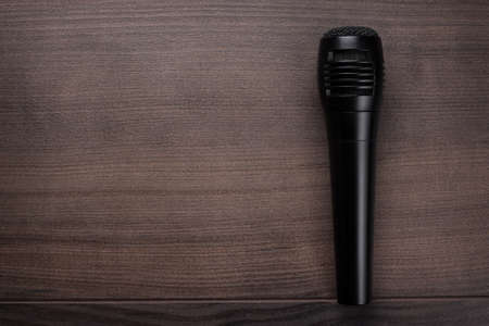 black mic on the brown wooden table