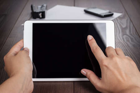women hands with tablet computer on the table
