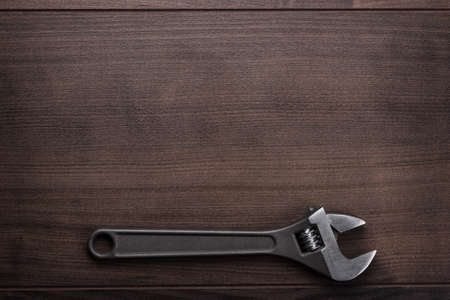 adjustable wrench on the brown wooden backgroundの写真素材